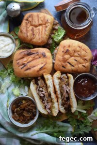 Steak sandwiches with cheese and onions.