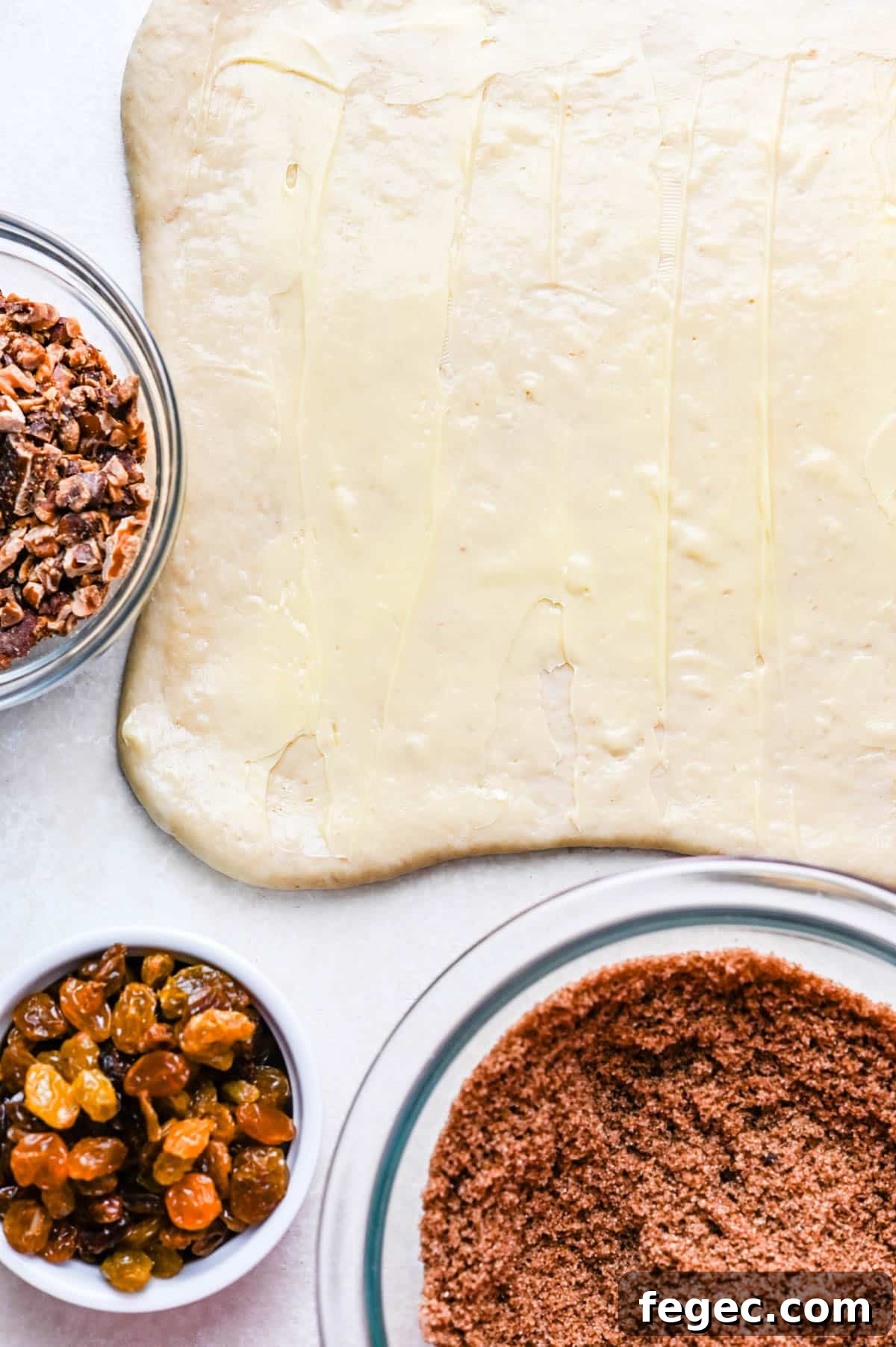 Rolling out the sweet roll dough and topping with butter