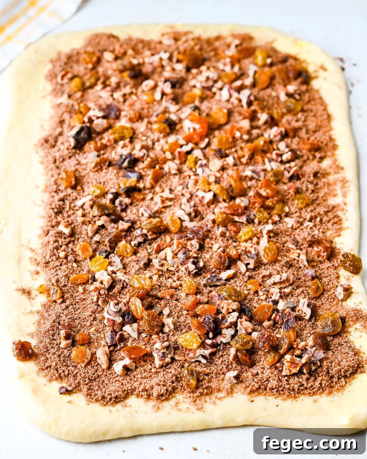 Spreading the butter with a cinnamon spice mix, raisins and chopped nuts. 