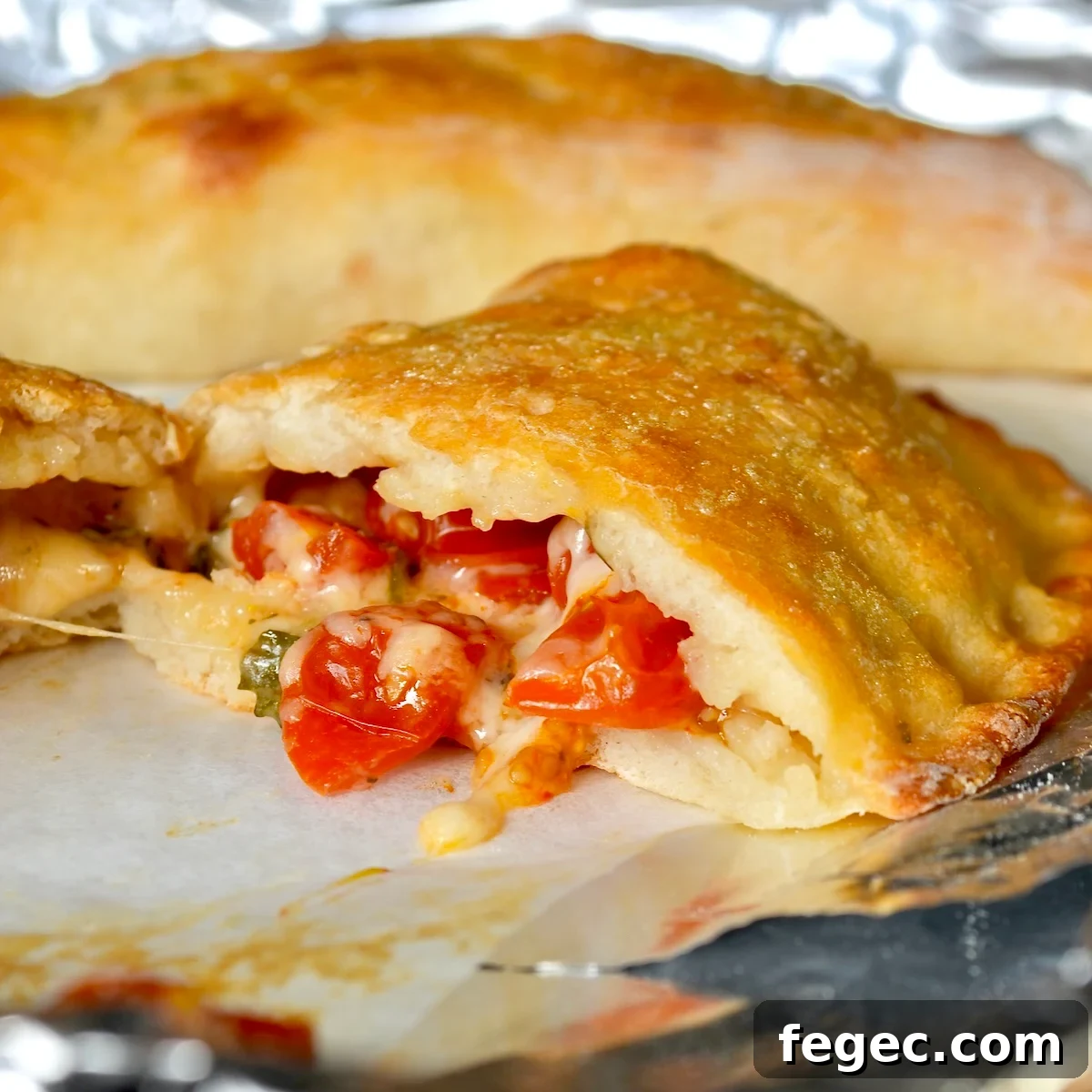Cheesy calzone split in half