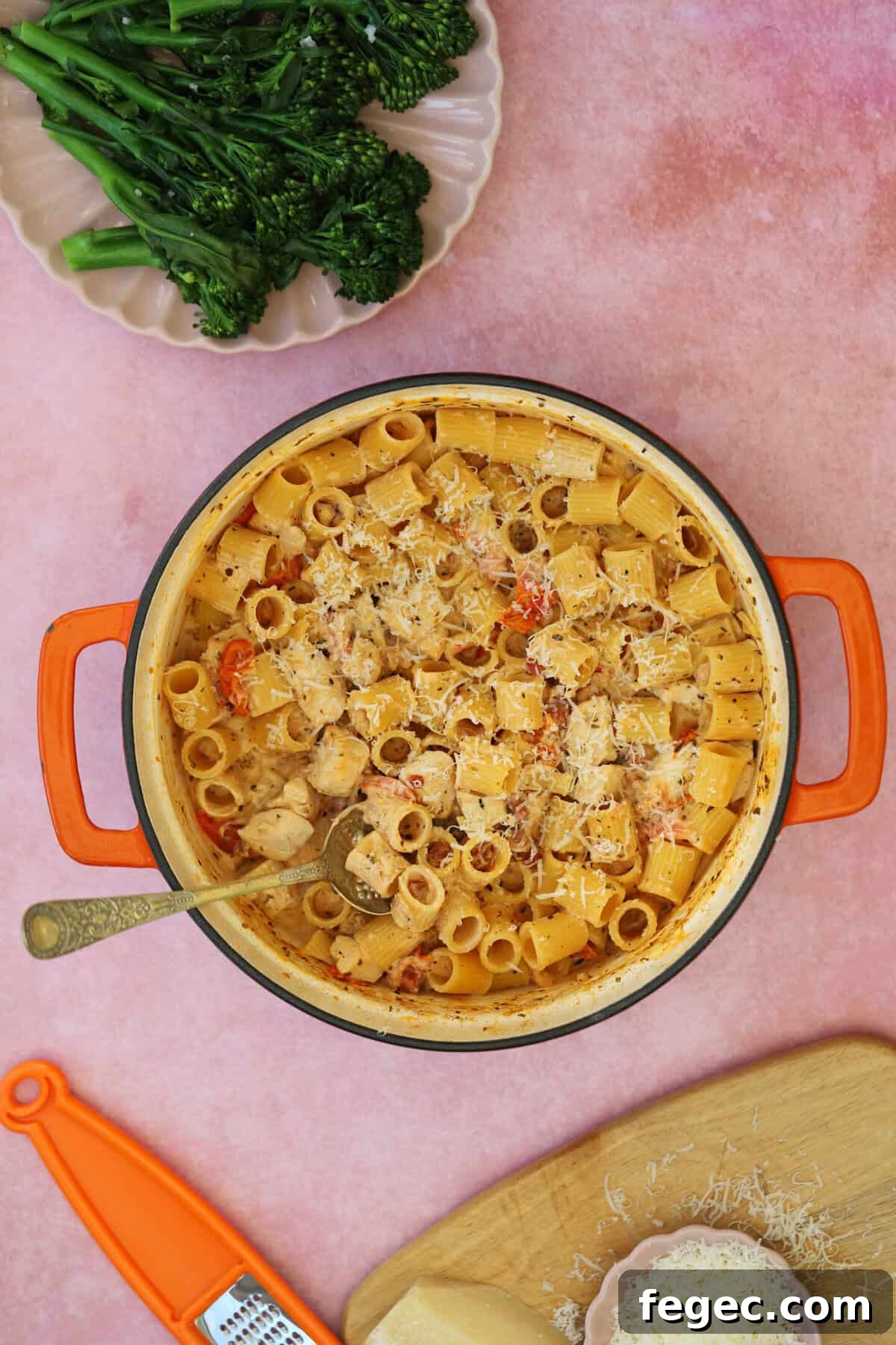 A pan of creamy chicken and chorizo pasta with a side of tenderstem broccoli.
