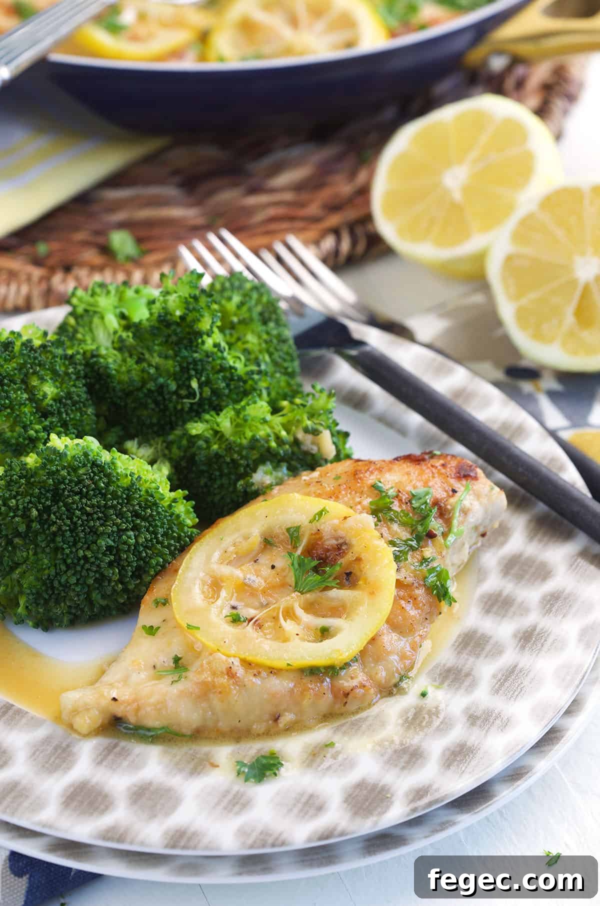 Lemon pepper chicken is plated with broccoli.
