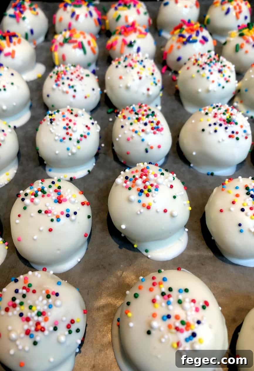 Perfect Cake Balls: Simple No-Bake Party Treats 8 cake bites on a pan with wax paper.