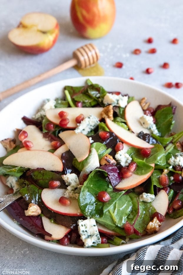Apple and blue cheese salad in a large white serving plate