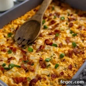 Cheesy Loaded Hash Brown Casserole with Bacon and Green Onions 13 Baked hashbrown casserole in rectangular baking dish.