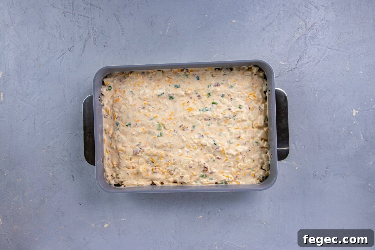 Cheesy Loaded Hash Brown Casserole with Bacon and Green Onions 6 All ingredients blended together and then spread into the casserole dish.
