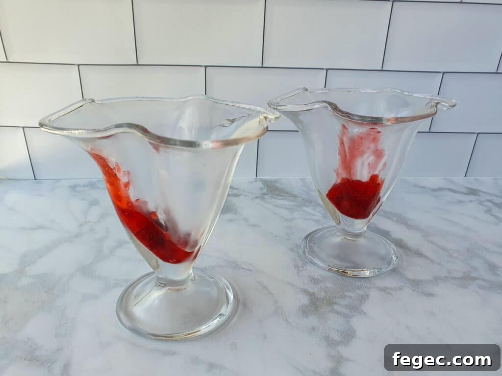 Adding strawberry sauce to the sundae.