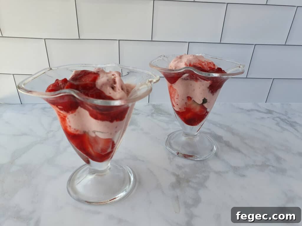 Adding strawberry sauce to the sundae.