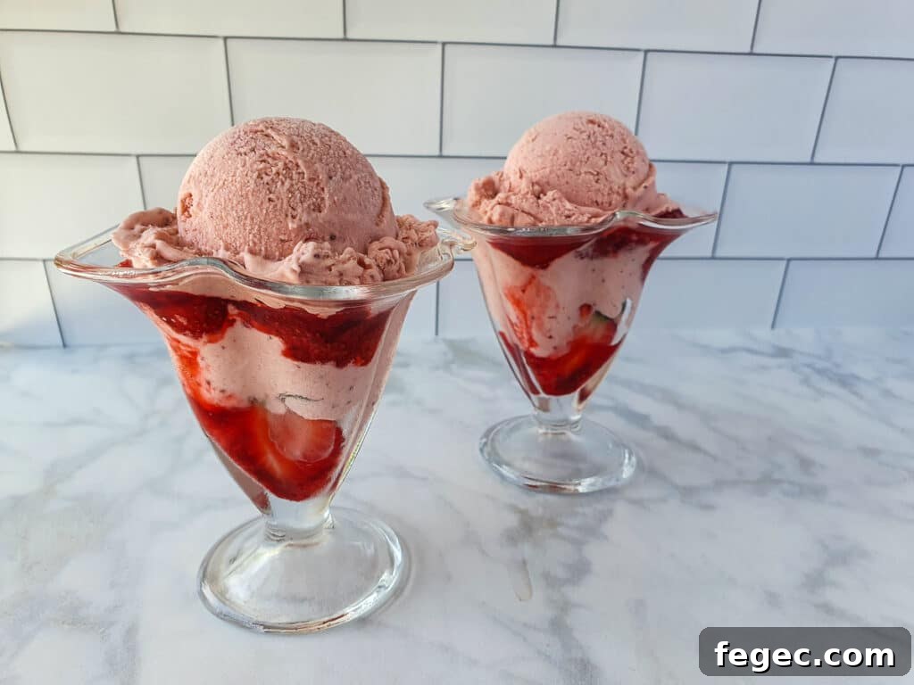 Adding strawberry ice cream to sundae.