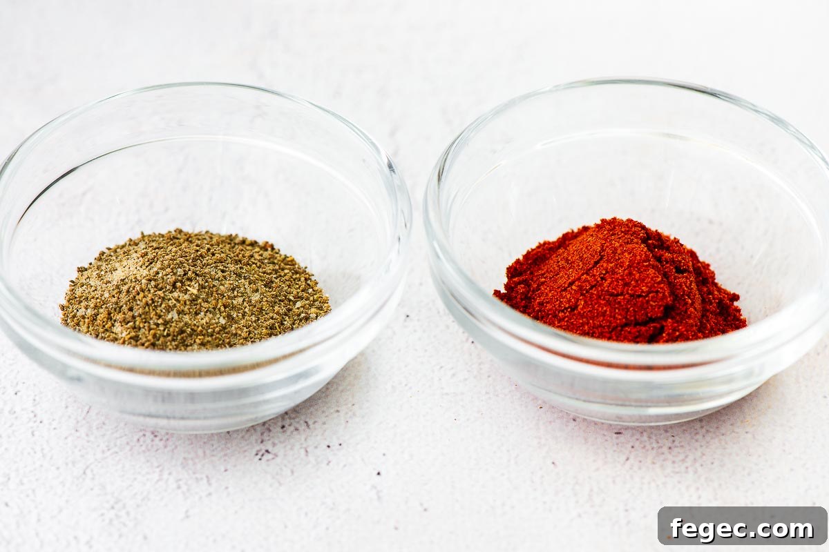 Close-up of celery salt and paprika on a concrete surface.