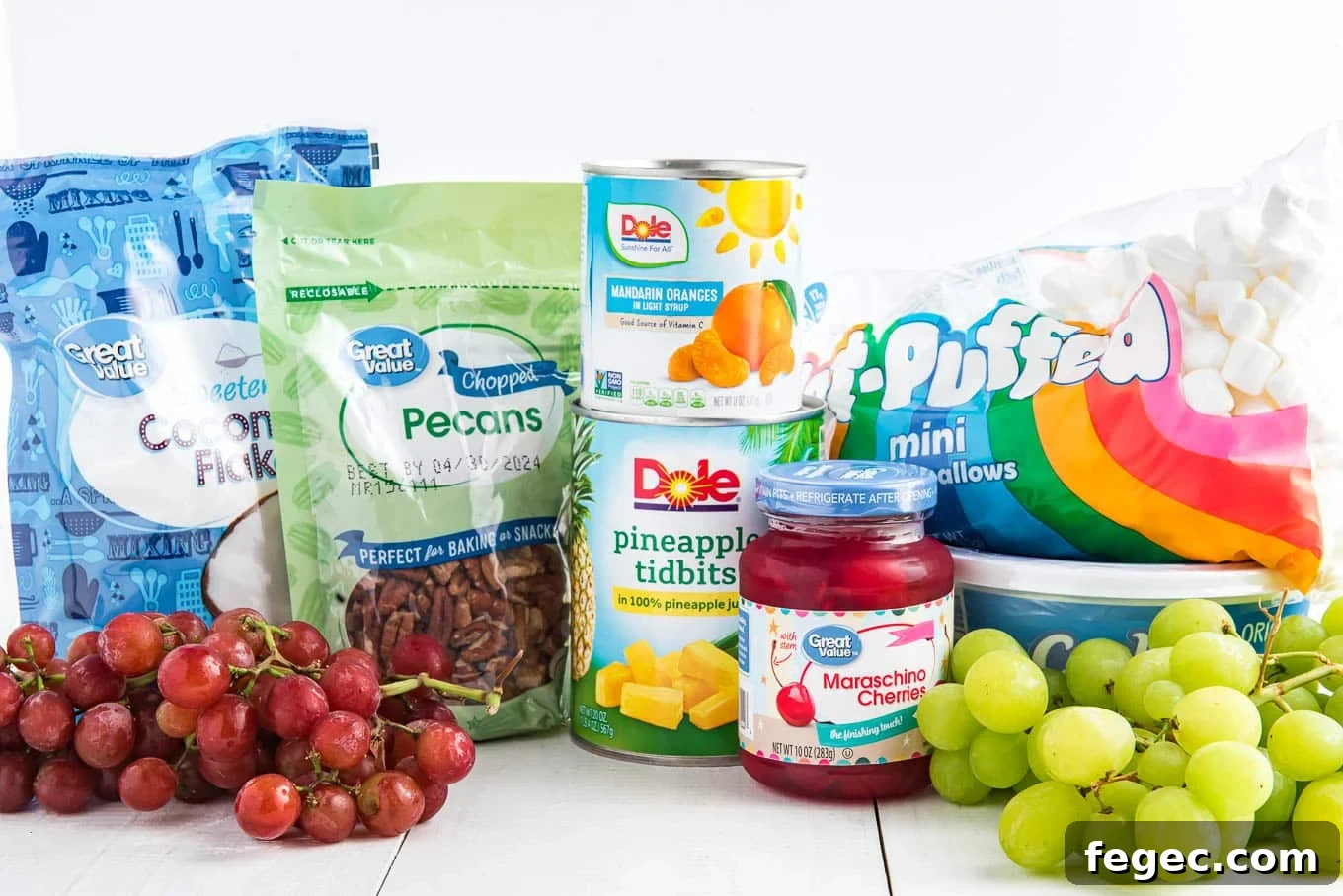 Ingredients to make fruit salad with marshmallows and cool whip on the table.