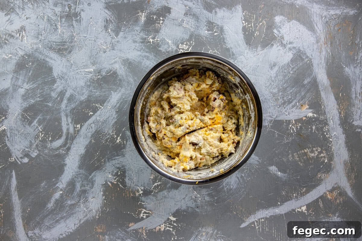 Cooked and crumbled bacon and shredded cheddar cheese folded into the mashed potato mixture.