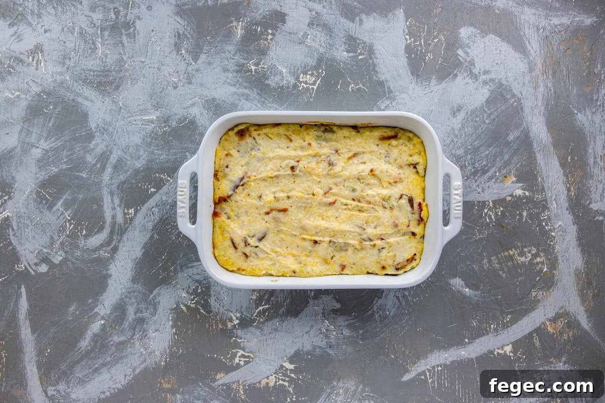 Unbaked potato mixture in a white casserole dish.