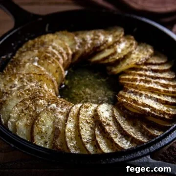 baked sliced potatoes in cast iron skillet