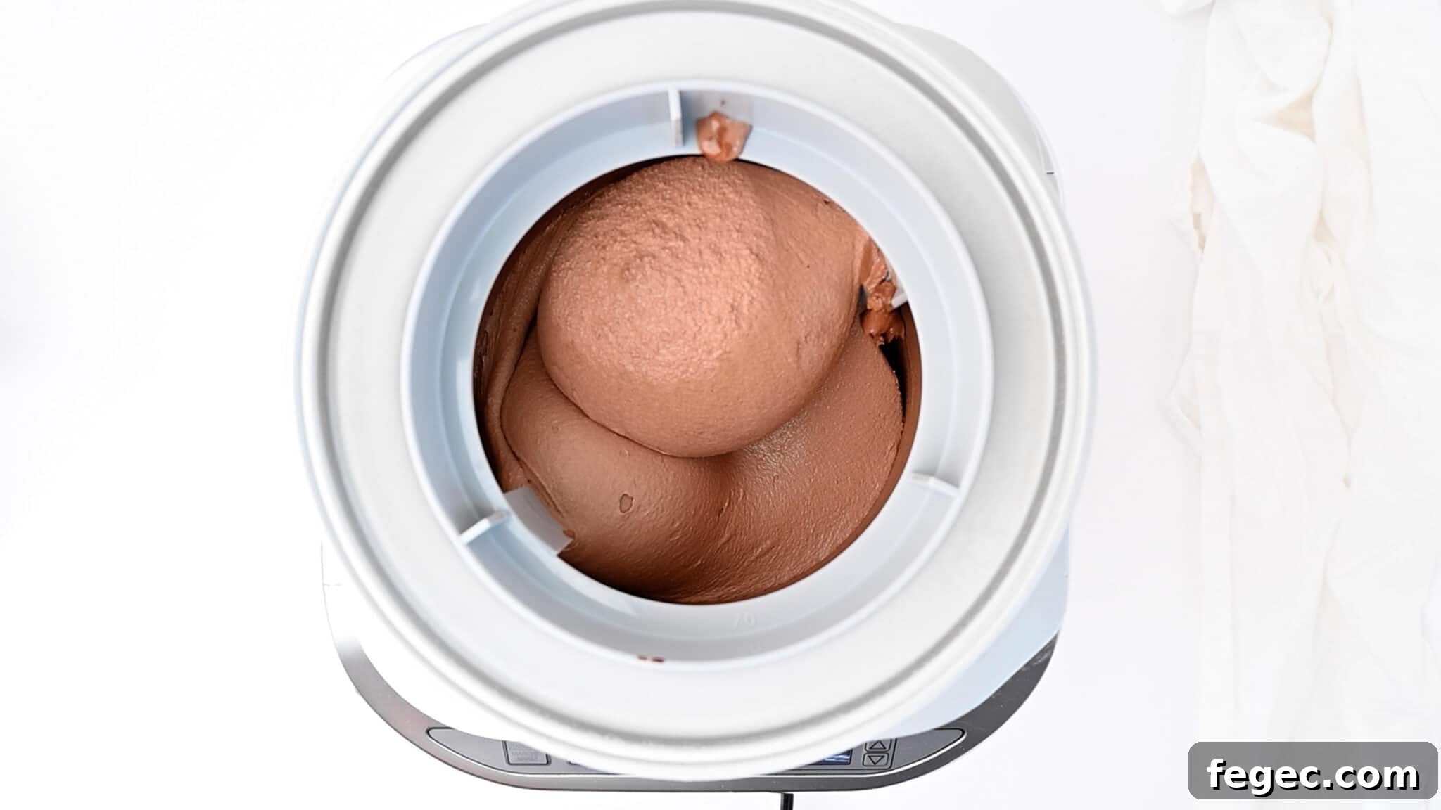 Keto chocolate ice cream being made in the ice cream maker.