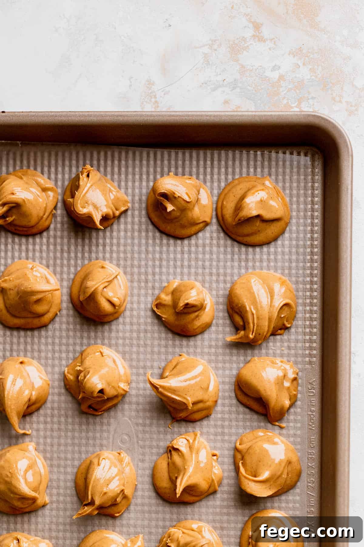 Peanut butter swirls on wax paper.