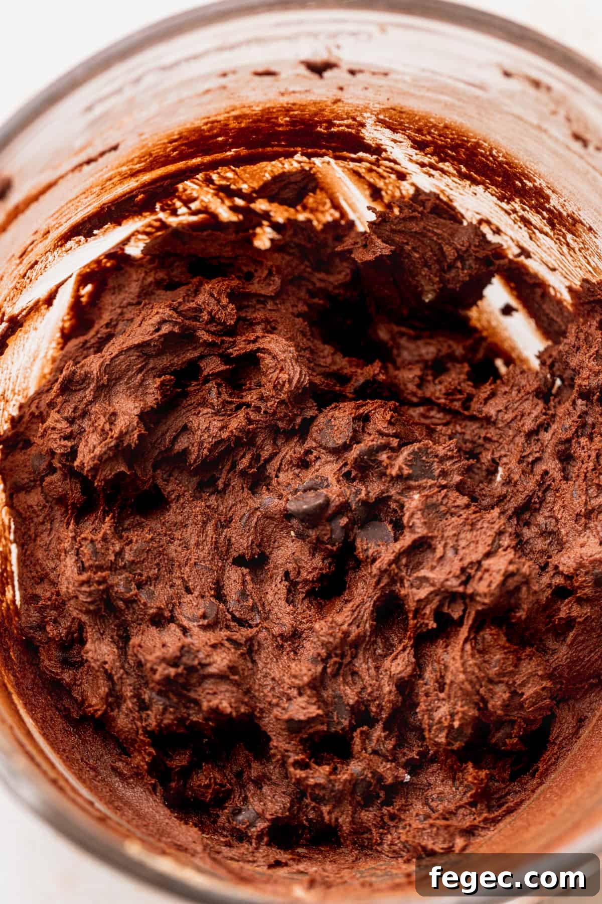 Chocolate cookie dough in a glass bowl.