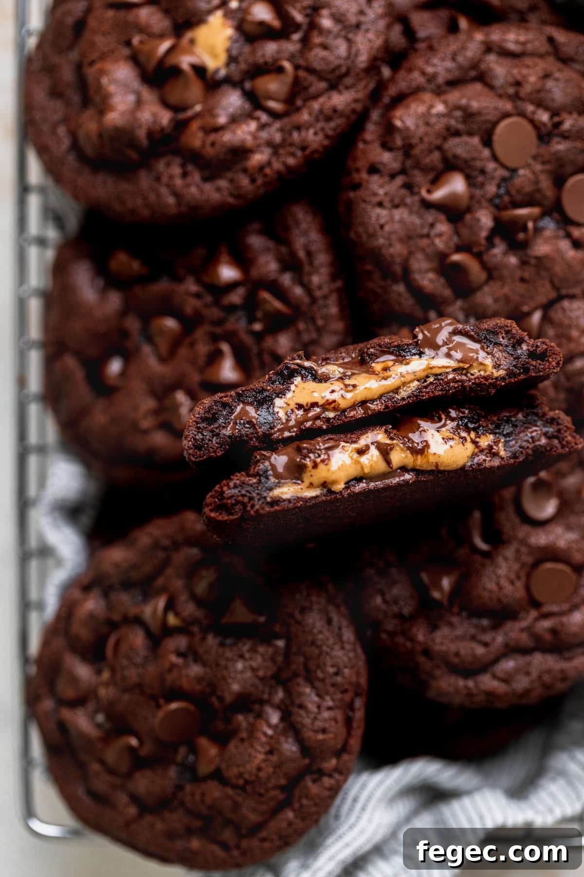Chocolate peanut butter stuffed cookies with a cookie took apart.