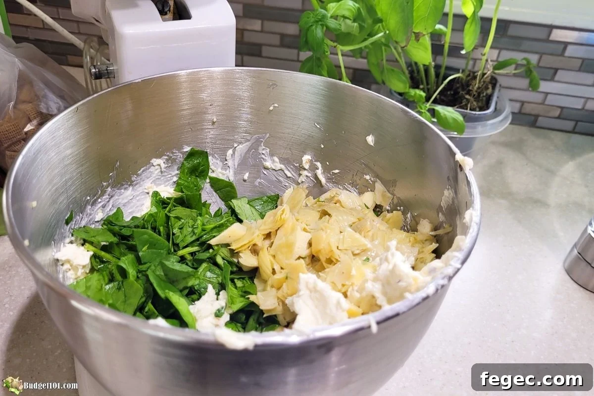 spinach artichoke dip ingredients in mixing bowl