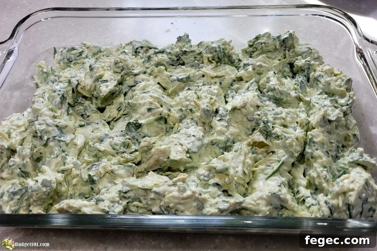raw spinach artichoke grinch dip in baking dish
