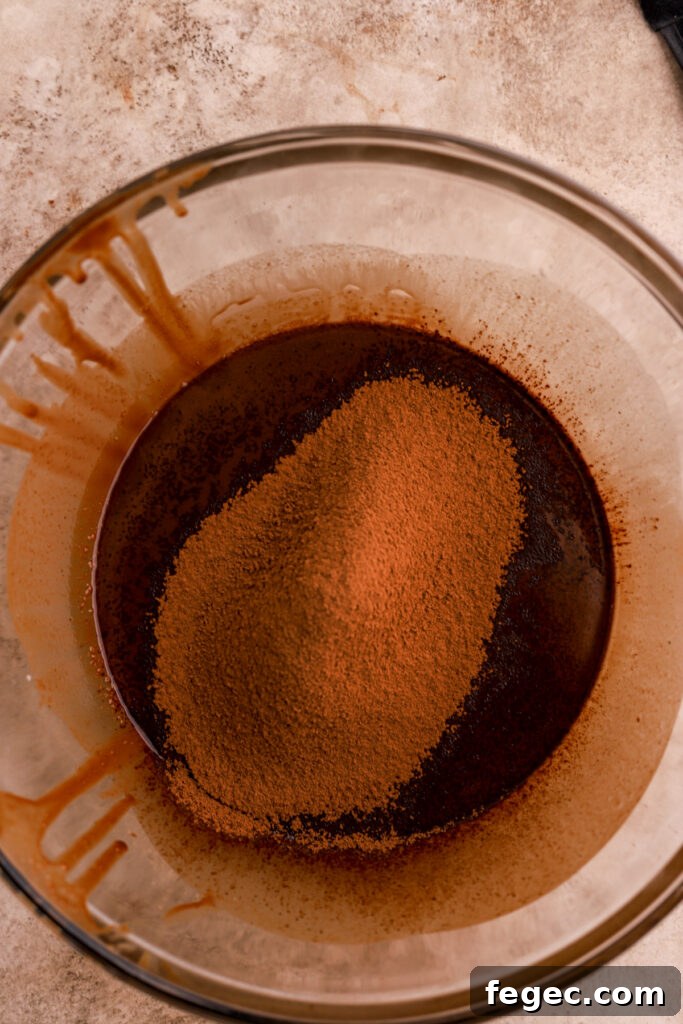Cocoa powder on top of chocolate batter in a mixing bowl. 