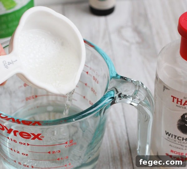 mixing witch hazel in glass cup for homemade face toner