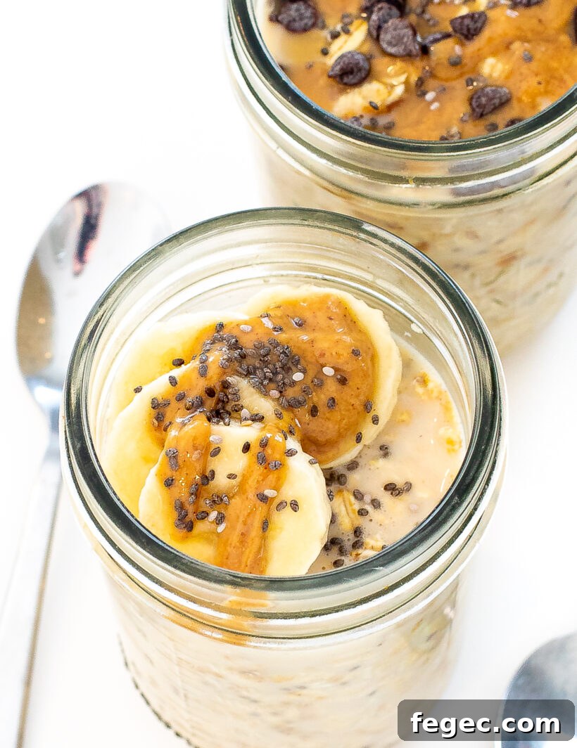 Creamy Peanut Butter Overnight Oats Recipe for Quick Breakfast 2 Jar of peanut butter oats with slices of banana and chia seeds on top.