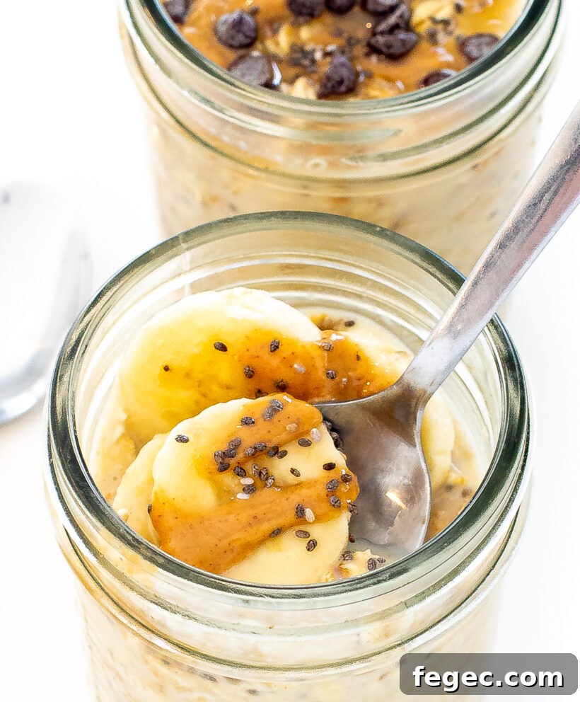 Creamy Peanut Butter Overnight Oats Recipe for Quick Breakfast 7 Close up shot of oats in a glass jar with a spoon dipping in.