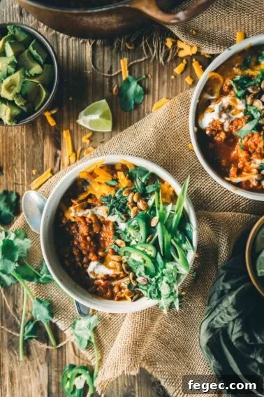 Two bowls of pumpkin chili with ground turkey.