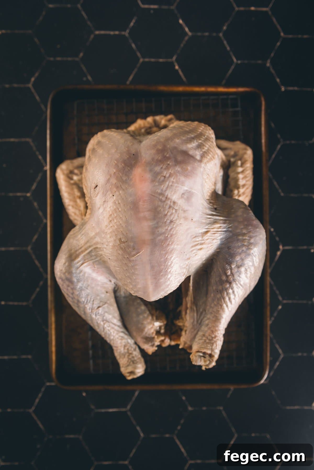 Turkey after being wet brined on a wire rack waiting to be cooked.