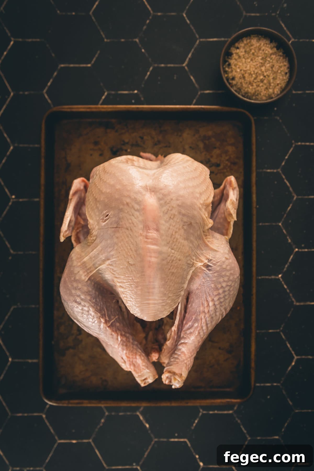 Turkey and brine ingredients on a black board.