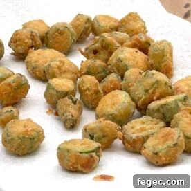 Cornmeal crusted fried okra draining on a paper towel.