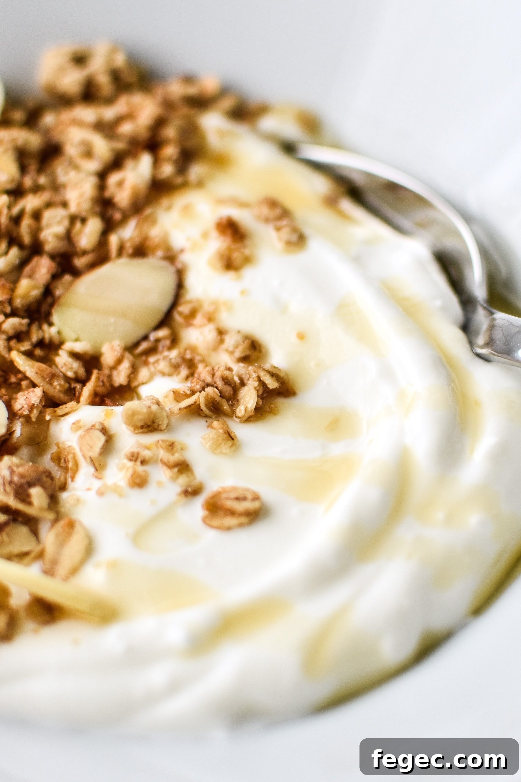 Freshly made yogurt with granola and a light maple syrup drizzle.