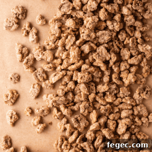 close up of candied walnuts spread out on brown paper