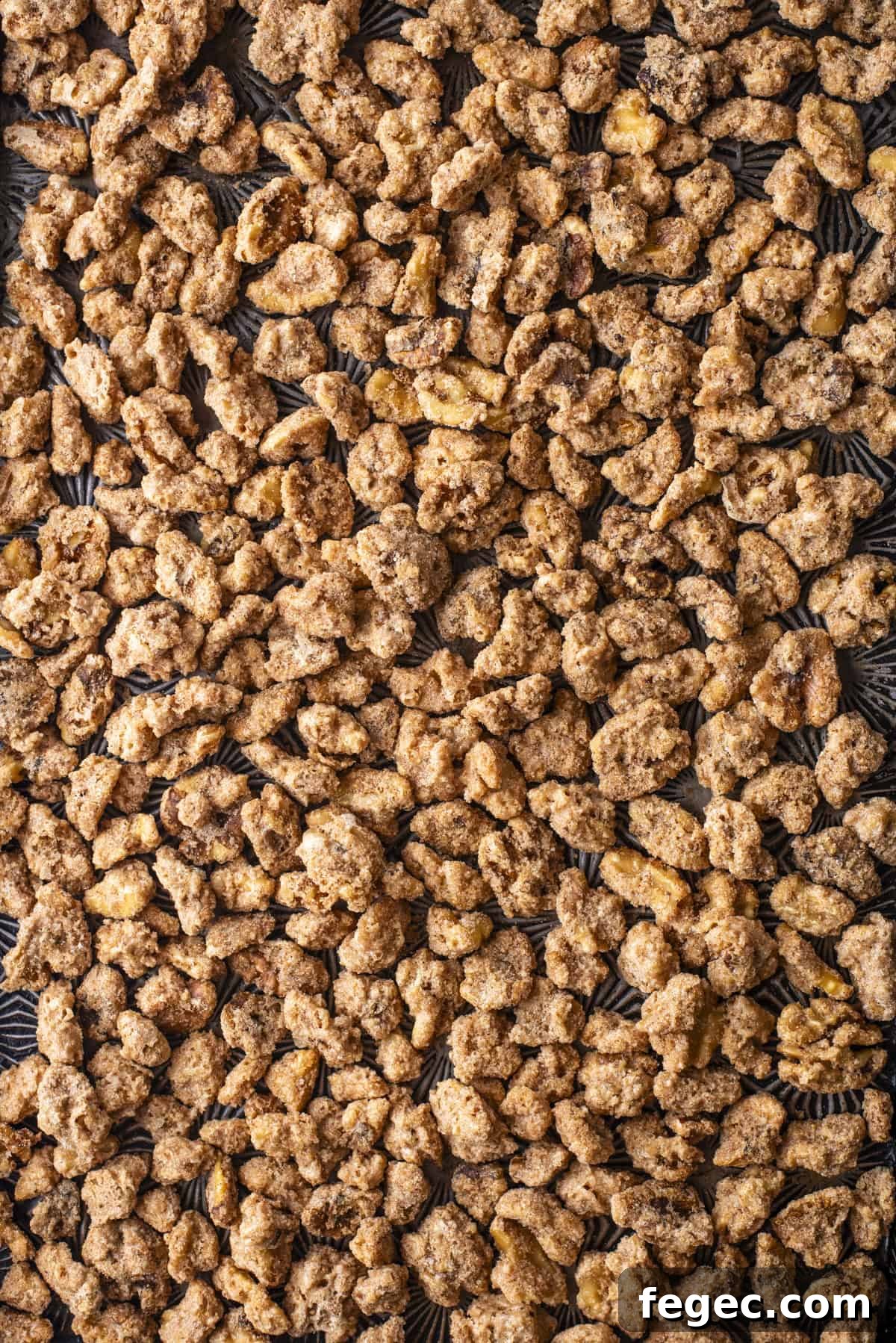 close up of lots of candied walnuts in one spread out layer
