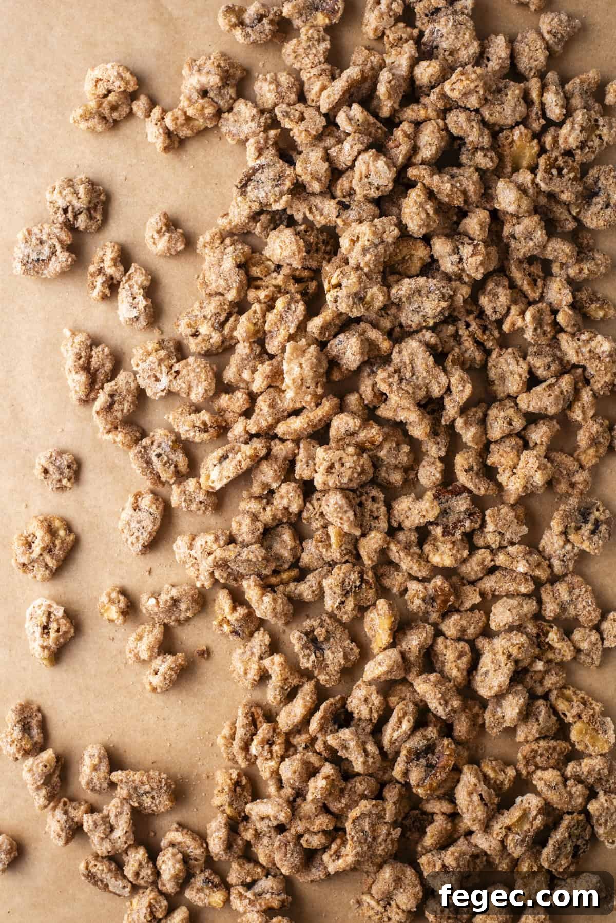candied walnuts spread out on top of brown paper