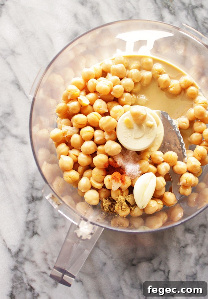 My Go To Hummus - This simple hummus recipe is perfect for dipping with veggies or crackers for a healthy appetizer, side, or snack. It only takes 10 minutes to make and uses simple pantry ingredients. It's rich, creamy, and super healthy. #hummus #glutenfree #vegan #easyrecipe | robustrecipes.com