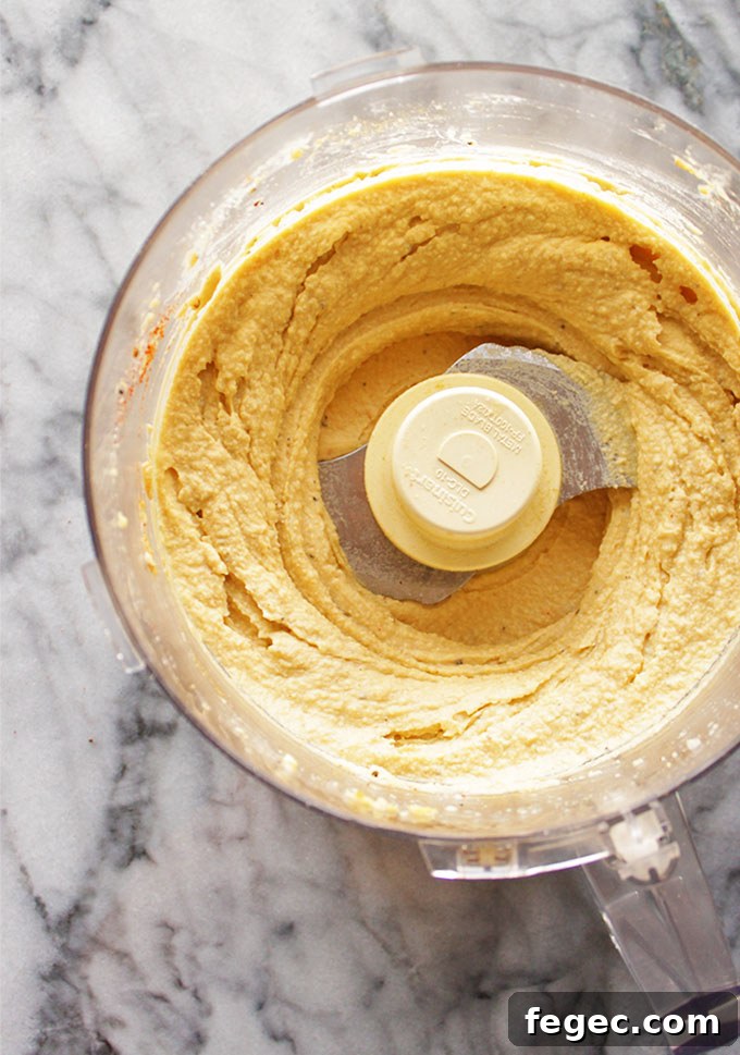 My Go To Hummus - This simple hummus recipe is perfect for dipping with veggies or crackers for a healthy appetizer, side, or snack. It only takes 10 minutes to make and uses simple pantry ingredients. It's rich, creamy, and super healthy. #hummus #glutenfree #vegan #easyrecipe | robustrecipes.com