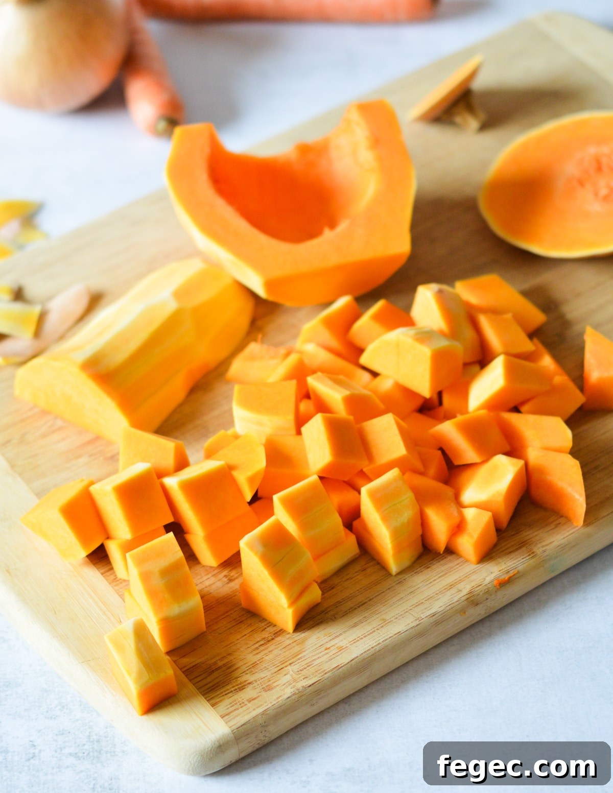 Creamy Roasted Butternut Squash Soup with Sage and Brown Butter 6 diced butternut squash on a cutting board.