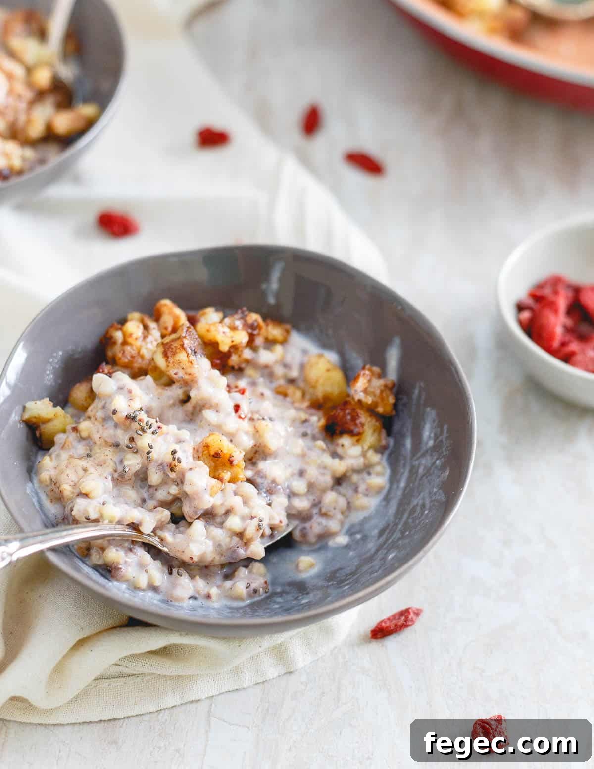 Step up your cereal game with this warm quinoa cereal bowl for breakfast. It's topped with caramelized bananas, walnuts, an almond butter drizzle, goji berries and some chia seeds!