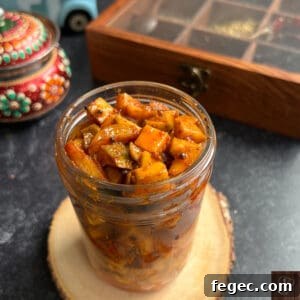 Traditional Kerala style mango pickle in a glass jar.