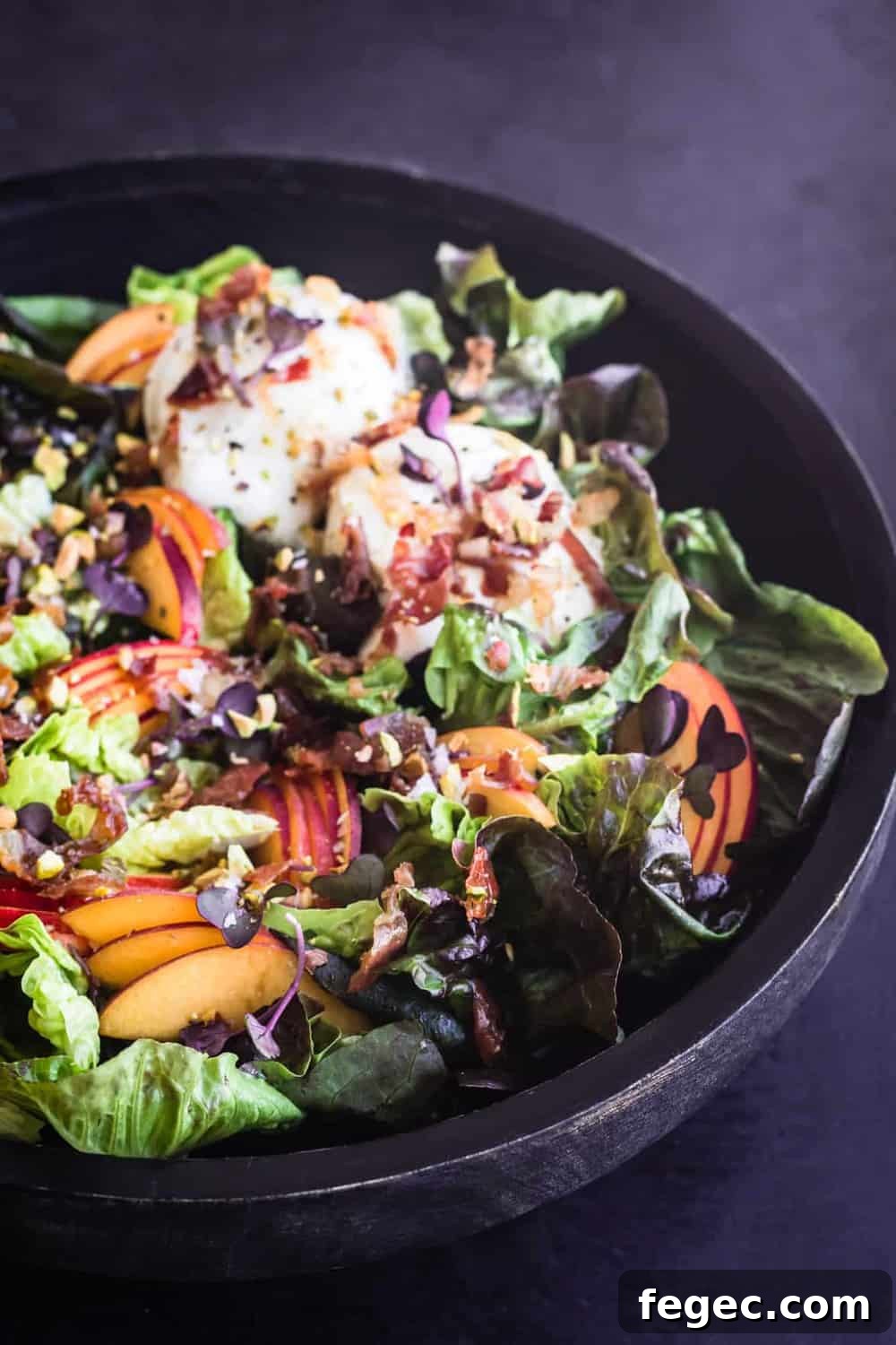 Stone Fruit & Crispy Prosciutto Salad with little gems and burrata alll ready to eat, side angle shot.