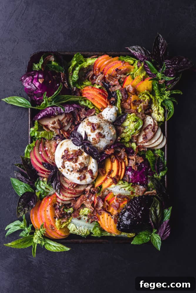 Peach Salad with Burrata & Crispy Bacon served on a tray, overhead shot on a black background.