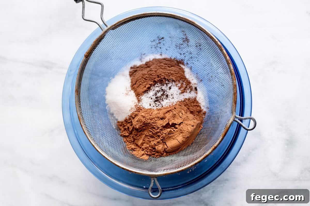 dry ingredients being sifted into a bowl