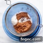 dry ingredients being sifted into a bowl