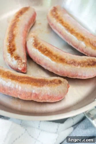 Brown sausages in skiller.