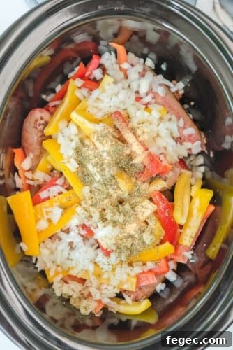 All ingredients for sausage and peppers in crockpot.