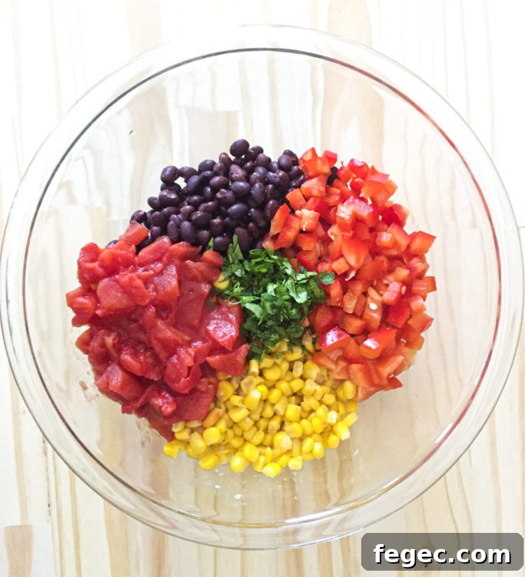 mixing black bean corn salad