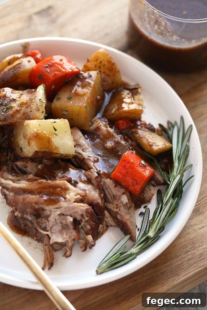 Pork roast and vegetables with balsamic wine glaze on a plate