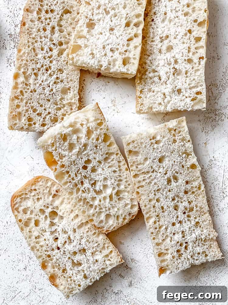 Crispy Vegan Garlic Bread Recipe You’ll Love 4 slices of bread on white surface